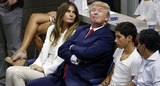 Republican presidential candidate Donald Trump, second from left, and his wife, Melania, left, watch play between Serena Williams and Venus Williams during a quarterfinal match at the U.S. Open tennis tournament, Tuesday, Sept. 8, 2015, in New York. (AP Photo/Jason DeCrow)