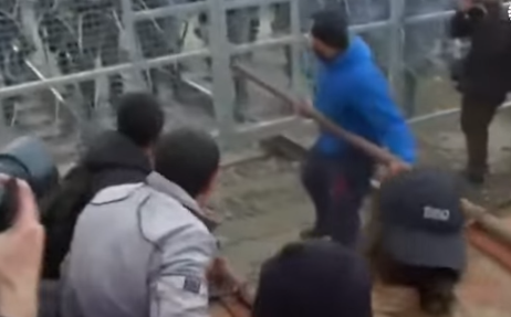 Migrants Use Battering Ram To Bust Through Border Fence, Attack Police